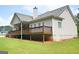 Spacious backyard and deck with lush greenery surrounding the home at 2204 Happy Hollow Se Ct, Conyers, GA 30094