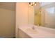 Bathroom vanity with a framed mirror, lighting and a sink featuring white countertops at 2204 Happy Hollow Se Ct, Conyers, GA 30094