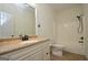 Bright bathroom featuring a vanity with stone countertops and a shower-tub combo at 2204 Happy Hollow Se Ct, Conyers, GA 30094