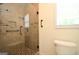 Bathroom featuring tiled shower with glass door and seat, plus a toilet and window at 2204 Happy Hollow Se Ct, Conyers, GA 30094