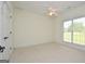 Bedroom featuring carpet flooring, ceiling fan, and a window at 2204 Happy Hollow Se Ct, Conyers, GA 30094