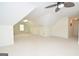 Spacious bonus room with sloped ceilings, neutral carpet and a ceiling fan, offering versatile living space at 2204 Happy Hollow Se Ct, Conyers, GA 30094