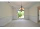 Bright dining room with decorative chandelier, large window, and neutral carpet at 2204 Happy Hollow Se Ct, Conyers, GA 30094