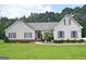 House exterior featuring beige vinyl siding, purple shutters, and a well-manicured lawn at 2204 Happy Hollow Se Ct, Conyers, GA 30094