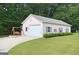 Detached garage with white door and a charming swing set outside at 2204 Happy Hollow Se Ct, Conyers, GA 30094