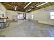 Spacious garage interior with shelving, peg board walls and ample lighting at 2204 Happy Hollow Se Ct, Conyers, GA 30094