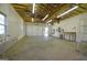 Spacious garage interior with shelving, peg board walls and ample lighting at 2204 Happy Hollow Se Ct, Conyers, GA 30094