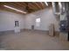 Spacious garage interior with shelving, peg board walls and ample lighting at 2204 Happy Hollow Se Ct, Conyers, GA 30094