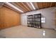 Spacious garage interior with shelving, peg board walls and ample lighting at 2204 Happy Hollow Se Ct, Conyers, GA 30094