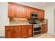 Kitchen with custom wood cabinets, stainless steel appliances, and granite countertops at 2204 Happy Hollow Se Ct, Conyers, GA 30094