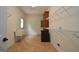 Large laundry room with wash sink, cabinet storage, wire shelving, and tile floors at 2204 Happy Hollow Se Ct, Conyers, GA 30094