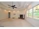 Expansive living room with brick fireplace, tray ceiling, and access to a deck at 2204 Happy Hollow Se Ct, Conyers, GA 30094