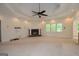 Spacious living room with ceiling fan, brick fireplace, and large window at 2204 Happy Hollow Se Ct, Conyers, GA 30094