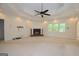 Large living room with a brick fireplace, ceiling fan, and recessed lighting at 2204 Happy Hollow Se Ct, Conyers, GA 30094