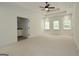Large main bedroom with tray ceiling, ceiling fan, carpet flooring, and access to the bathroom at 2204 Happy Hollow Se Ct, Conyers, GA 30094