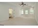 Large main bedroom with tray ceiling, ceiling fan, carpet flooring, and access to the bathroom at 2204 Happy Hollow Se Ct, Conyers, GA 30094