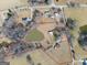 Aerial view of a large property with a house and pond at 444 Agape Rd, Carrollton, GA 30116