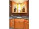 Corner vanity with granite countertop and mirrored medicine cabinet at 444 Agape Rd, Carrollton, GA 30116