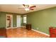 Charming bedroom with wood floors, ceiling fan and access to bathroom at 444 Agape Rd, Carrollton, GA 30116