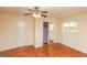 Bedroom with wood floors, mirrored closet, and ceiling fan at 444 Agape Rd, Carrollton, GA 30116