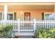 Inviting front porch with white picket fence and landscaping at 444 Agape Rd, Carrollton, GA 30116