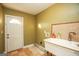 Laundry room with utility sink, built-in shelving, and exterior access at 444 Agape Rd, Carrollton, GA 30116