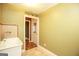 Well-lit laundry room with tile flooring and access to exterior at 444 Agape Rd, Carrollton, GA 30116