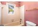 Bathroom with shower/tub combo and pink tile at 7943 Lake Ridge Dr, Jonesboro, GA 30236