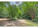 Landscaped backyard with mature trees at 731 Airline Rd, Mcdonough, GA 30252