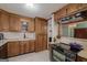 Kitchen features wood cabinets, updated appliances, and tile flooring at 731 Airline Rd, Mcdonough, GA 30252