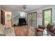 Living area with hardwood floors, a wood-burning stove and access to deck at 731 Airline Rd, Mcdonough, GA 30252