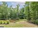 Serene pond with a wooden bench, surrounded by lush greenery at 731 Airline Rd, Mcdonough, GA 30252