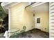 Side patio with small table and chairs near exterior door at 731 Airline Rd, Mcdonough, GA 30252
