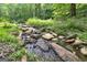 Charming stream with natural rock formations at 731 Airline Rd, Mcdonough, GA 30252