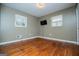 Well-lit bedroom with hardwood floors, neutral walls and two windows at 653 Temple St, Lithia Springs, GA 30122
