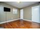 Hardwood floor bedroom with neutral walls and a large window at 653 Temple St, Lithia Springs, GA 30122