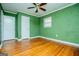 Bedroom with green walls, hardwood floors and ceiling fan at 653 Temple St, Lithia Springs, GA 30122