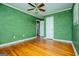 Bedroom with green walls, hardwood floors and ceiling fan at 653 Temple St, Lithia Springs, GA 30122