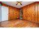 Bedroom with wood paneled walls and hardwood floors at 653 Temple St, Lithia Springs, GA 30122
