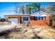 Brick ranch house with attached garage and mature trees at 653 Temple St, Lithia Springs, GA 30122