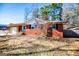 Brick ranch house with attached garage and mature trees at 653 Temple St, Lithia Springs, GA 30122