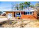 Brick ranch house with attached garage and mature trees at 653 Temple St, Lithia Springs, GA 30122
