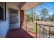 Front porch with metal railing and screen door at 653 Temple St, Lithia Springs, GA 30122