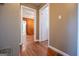 Hallway with wood floors connecting various rooms at 653 Temple St, Lithia Springs, GA 30122