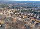 Aerial community view showcasing the density of housing, winding roads, and surrounding forest at 301 Dunstans Pass, Marietta, GA 30066