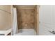 Bathroom with tan tile shower, shower curtain, and built-in soap holder at 301 Dunstans Pass, Marietta, GA 30066