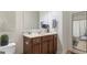 Bright bathroom featuring a vanity with storage, a framed mirror, and decorative touches at 301 Dunstans Pass, Marietta, GA 30066