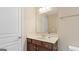 Bathroom with tan walls, vanity, cabinets and a large mirror at 301 Dunstans Pass, Marietta, GA 30066