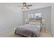 Sunlit bedroom boasts neutral decor, window and ceiling fan at 301 Dunstans Pass, Marietta, GA 30066