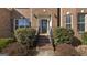 Charming brick home featuring a front door with glass accents and landscaped front yard at 301 Dunstans Pass, Marietta, GA 30066